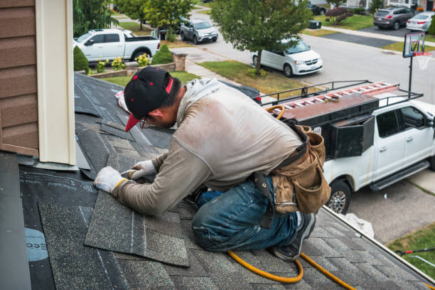 Professional Roof Replacement technician working in Mastic Beach, NY